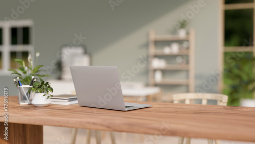 A back view of a laptop computer on a wooden table in a contemporary bright room. © bongkarn