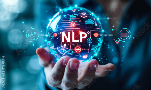 Person holding holographic sphere displaying NLP and technology icons, concept of natural language processing and its applications in various domains such as AI, data analysis, and automation photo