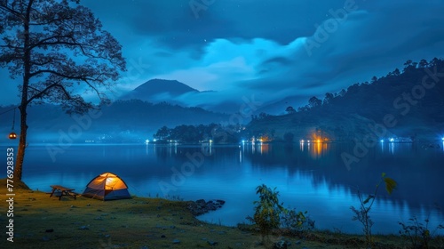 Travel Camping tent beside a blue lake, blue night sky, mountain is the background