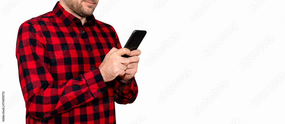 Man in red casual shirt messages online using his mobile phone on white background. Man in red casual shirt messages online using his mobile phone on white background.