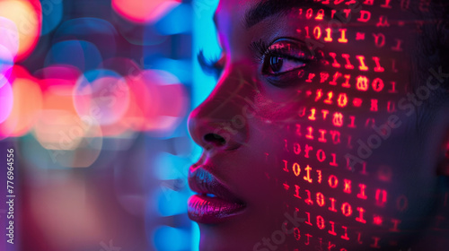 A woman's face is projected onto a screen with a series of binary numbers. The image has a futuristic and technological feel to it, with the woman's face appearing as a digital representation.