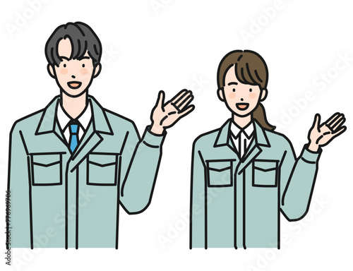 案内をする作業服姿の男性と女性（上半身）
