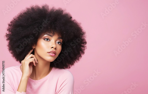 Portrait of a beautiful woman with afro hairstyle on pastel background