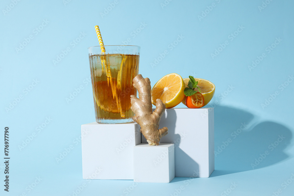 A glass of cold tea on a blue background - obrazy, fototapety, plakaty 