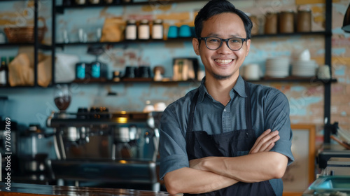 The Southeast Asian owner of the small coffee shop business smiled and crossed his arms