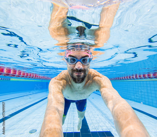 Underwater view of smiling swimmer in pool