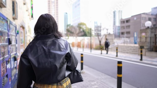 Slow-motion video of a Japanese woman in her 20s walking around Gotanda Station, Shinagawa-ku, Tokyo while operating her smartphone in winter 冬の東京都品川区五反田の駅周辺をスマートフォンを操作しながら歩く20代の日本人女性のスローモーション映像 photo