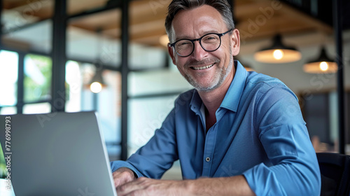 Happy mature business man executive manager looking at laptop computer watching online webinar or having remote virtual meeting, video conference call negotiation. Generative AI
