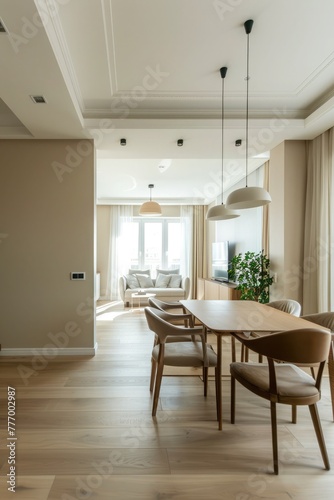 Elegant contemporary dining area in a luxury home with large windows  inviting natural light and tasteful decorations.