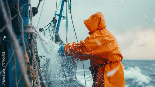 The hard work of a fisherman on a trawler in the sea. Senior fisherman in yellow clothes on fishing boat in the ocean