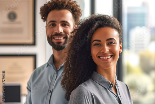 Smiling business man and woman of different races indoors