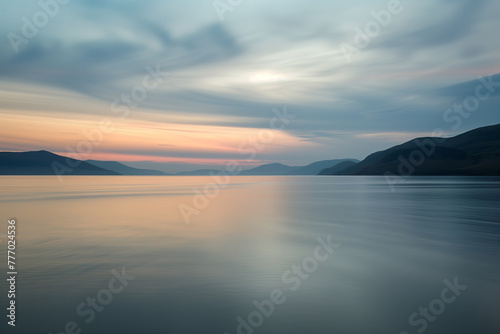 Serene lake at dusk, mountains silhouette, sky painted with soft hues of sunset colors, tranquil beauty