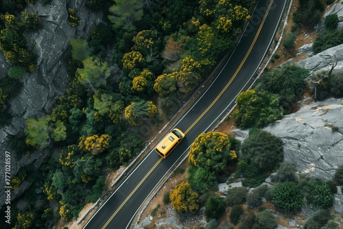 Yellow car on winding road through rocky terrain