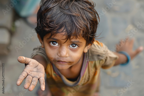Beggar child with outstretched hand asking for food