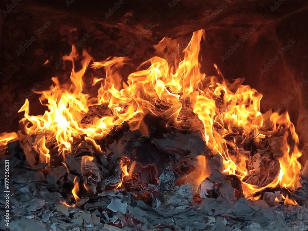 Burning firepaper and coals of a fire. Background for grilled food with fire. Burning firepaper and coals of a fire. Background for grilled food with fire.