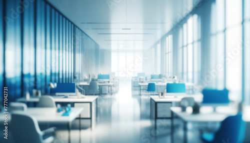 Blurred light background of a corporate office with desks and monitors bathed in cool blue tones. No people. Concept for design  presentation  digital displays in conferences