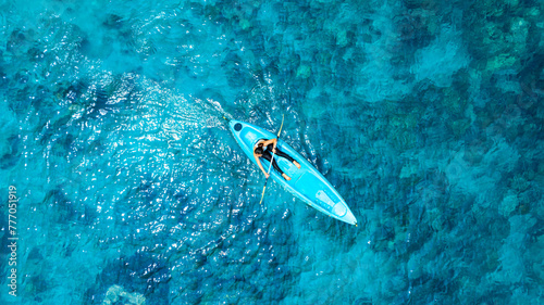 Aerial view of a kayak in the blue sea .Woman kayaking She does water sports activities 