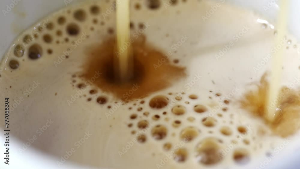 close-up. Two jets of coffee pour from the coffee machine in a cup. Making delicious and aromatic natural coffee at home. close-up. Two jets of coffee pour from the coffee machine in a cup. Making delicious and aromatic natural coffee at home.