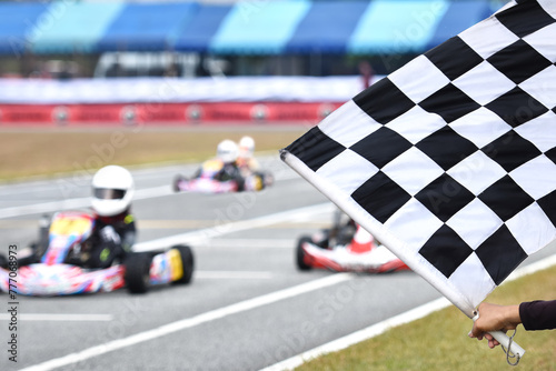 Track officer waving the finish flag for go kart racing at the finish line photo