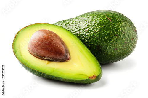 Half-cut ripe avocado with pit on white. Perfectly ripe avocado cut in half on white background