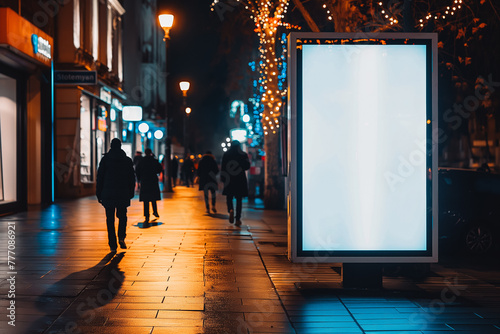 Mockup. Blank white vertical advertising banner billboard stand on the sidewalk at night