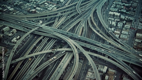 An expansive network of crisscrossing highways and bridges connecting the urban landscape like a web from above.