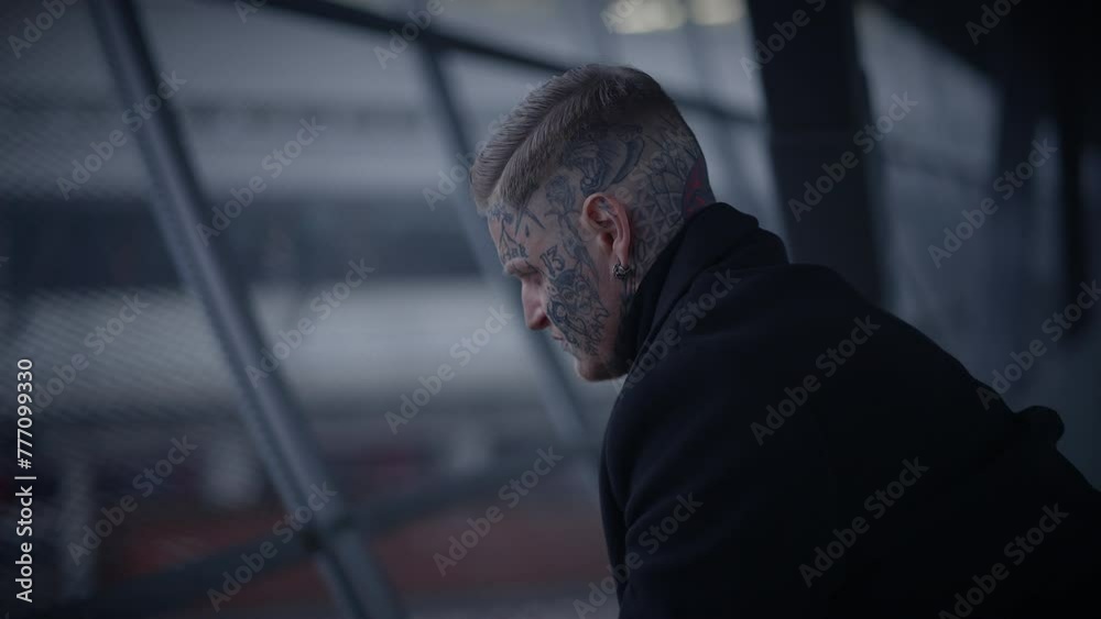 Intimidating Maverick Rebel Man with Head and Face Tattoos in Provoking Style Intimidating Maverick Rebel Man with Head and Face Tattoos in Provoking Style