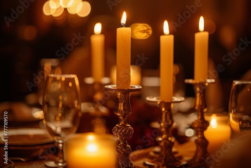 A group of lit candles placed on top of a table, creating a warm and inviting ambiance