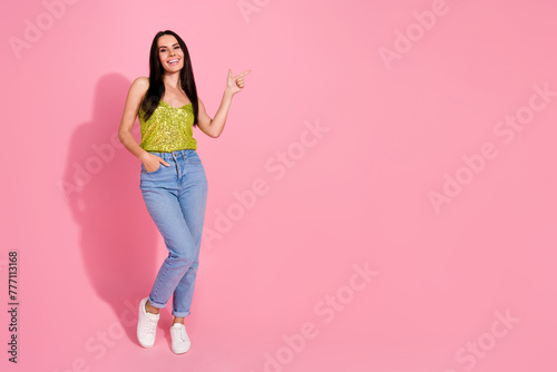 Photo of adorable pretty nice girl wear trendy clothes introduce empty space isolated on pink color background © deagreez