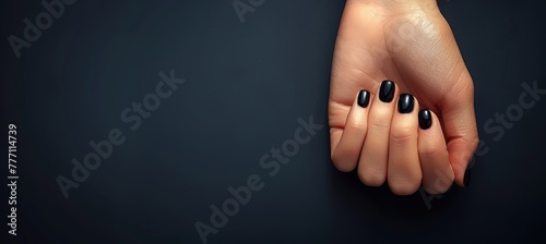Close up of elegant woman s hand with chic black nail polish, showcasing glamour and style photo