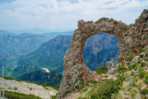 View of circular rock formation in the mountains. Natural monument Hajdučka vrata in Čvrsnica mountain. Famous hiking place in Bosnia and Herzegovina.