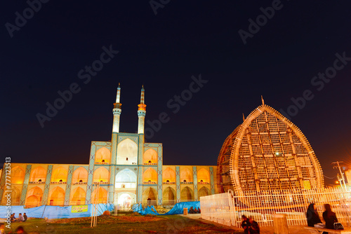Beautiful view of the Amir Chakhmaq Complex and colorful illuminated fountain in the historical city of Yazd at sunset. Unique Persian architecture of the ancient town. photo