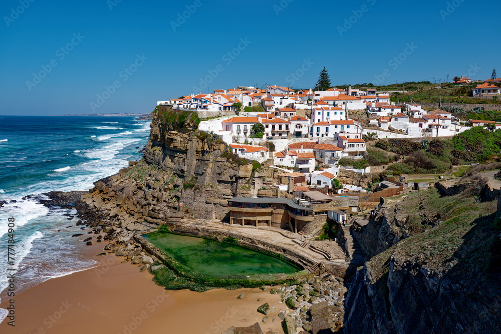 Azenhas do Mar, Portugal. Natural pool in the ocean, next to the cliff and a seaside village during sunset. Best destinations in the world. Most visited places. Holidays. Scenic and exotic.