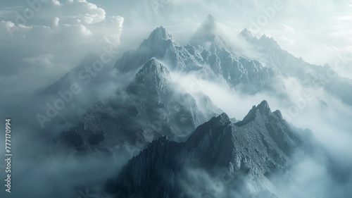 Majestic mountain range rising above a dense fog, creating an ethereal atmosphere. #777170994