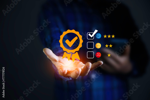 service satisfaction concept. Positive emotion smiley face icon at hand and showing the best quality assurance with golden stars. feedback, review, good, best, good product and service, quality.