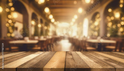 empty wood table top on blur light gold bokeh of cafe restaurant in dark background © netsay