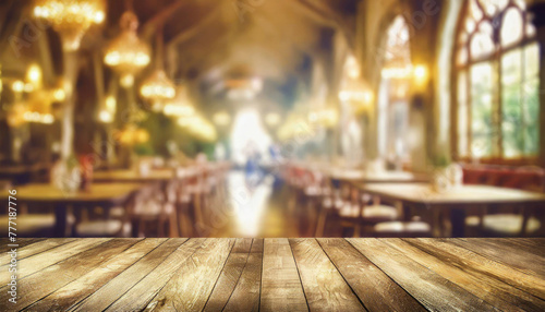 empty wood table top on blur light gold bokeh of cafe restaurant in dark background