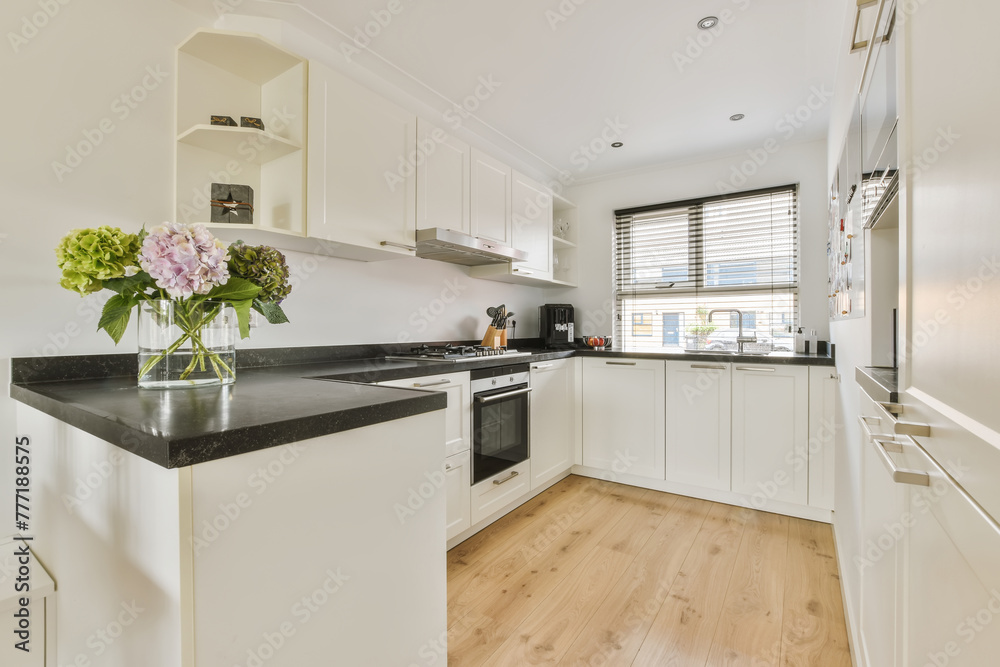 Modern kitchen interior with natural light and flowers Modern kitchen interior with natural light and flowers