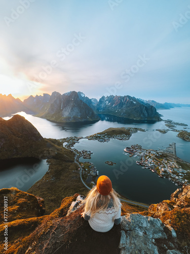 Woman traveling in Lofoten islands hiking Reinebringen mountain, girl enjoying sunset aerial view in Norway summer active vacations solo traveler outdoor healthy lifestyle adventure trip