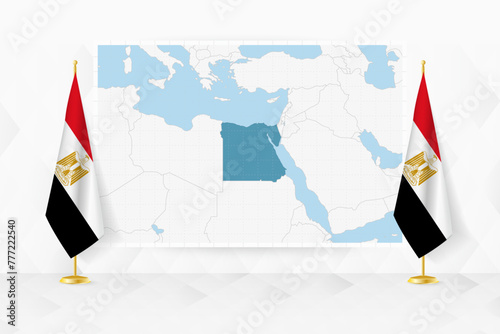 Map of Egypt and flags of Egypt on flag stand.