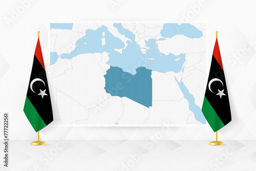 Map of Libya and flags of Libya on flag stand.