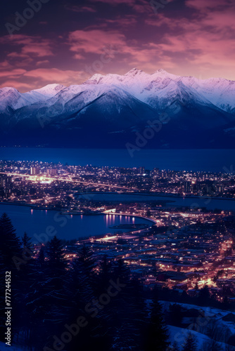 A city illuminated at night, nestled between serene dark waters and majestic snow-capped mountains under a vibrant sunset sky