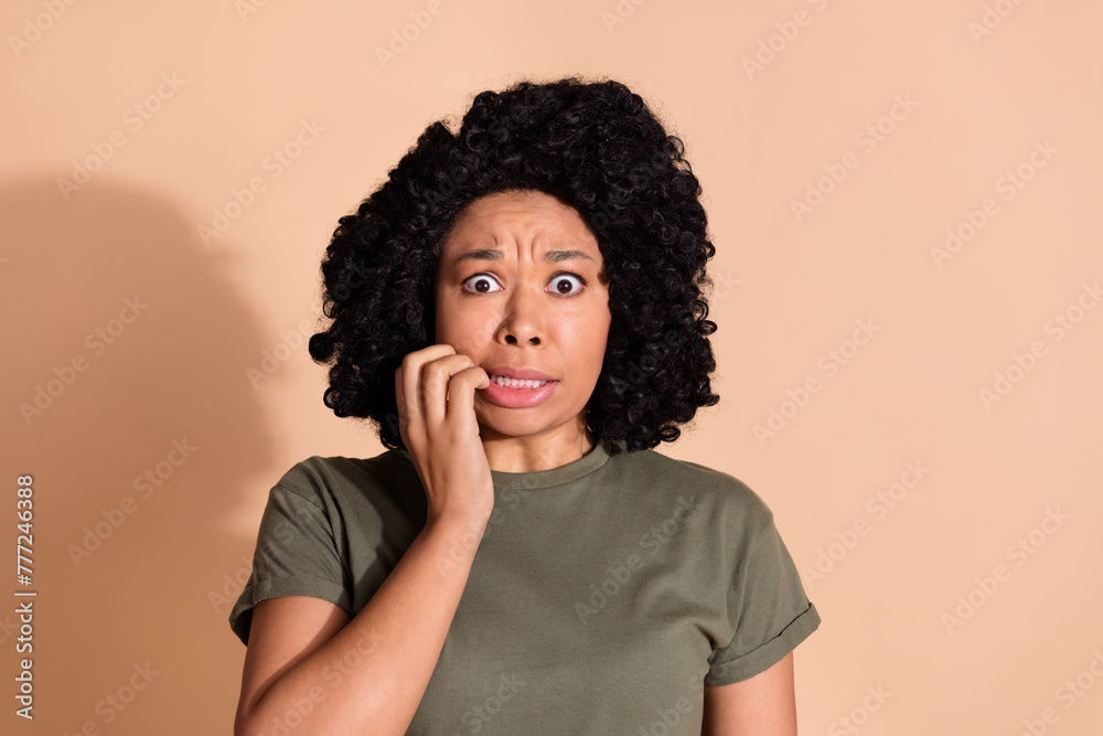Photo portrait of pretty young woman bite nails frightened dressed trendy khaki outfit isolated on beige color background Photo portrait of pretty young woman bite nails frightened dressed trendy khaki outfit isolated on beige color background