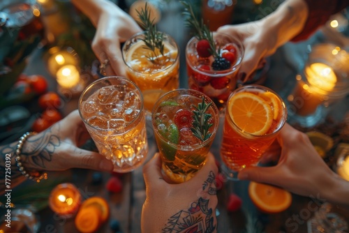Top angle shot capturing the vibrant colors and garnishes of cocktails being cheered by friends at an intimate gathering