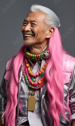 A man with pink hair and a pink shirt is wearing a lot of jewelry