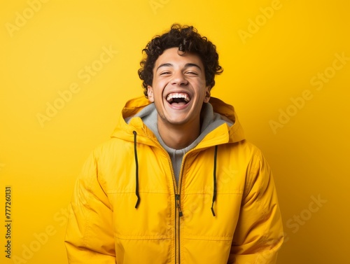 Young Man Laughing in Yellow Jacket