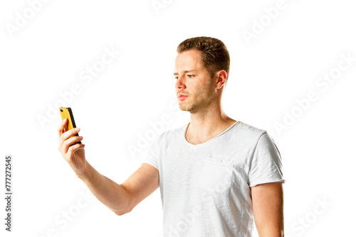 A man in a white t-shirt looking at his yellow phone, isolated on a white background, symbolizing modern communication
