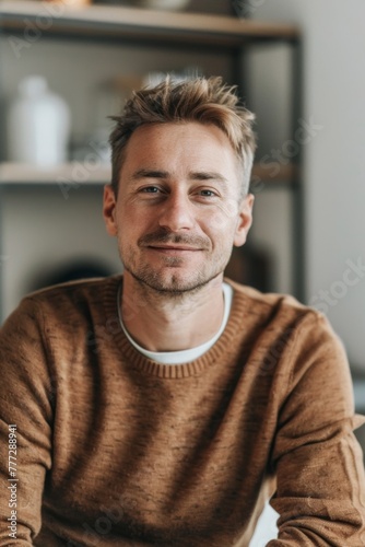 A man in the office. He is dressed in casual clothes. 