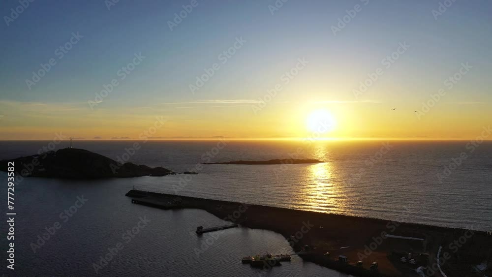 The beautiful nature of the Lofoten Islands. Mountains and fjords of Norway. Snow covered mountain range on coastline in winter. Aerial view of fjord, reflection in water. The beautiful nature of the Lofoten Islands. Mountains and fjords of Norway. Snow covered mountain range on coastline in winter. Aerial view of fjord, reflection in water.