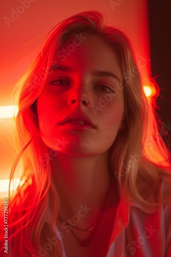 Portrait of a blonde woman in red light 